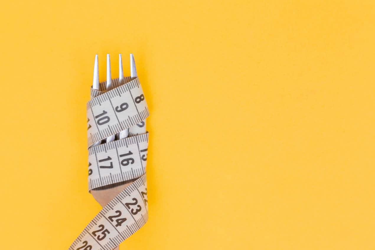 measuring tape around a fork